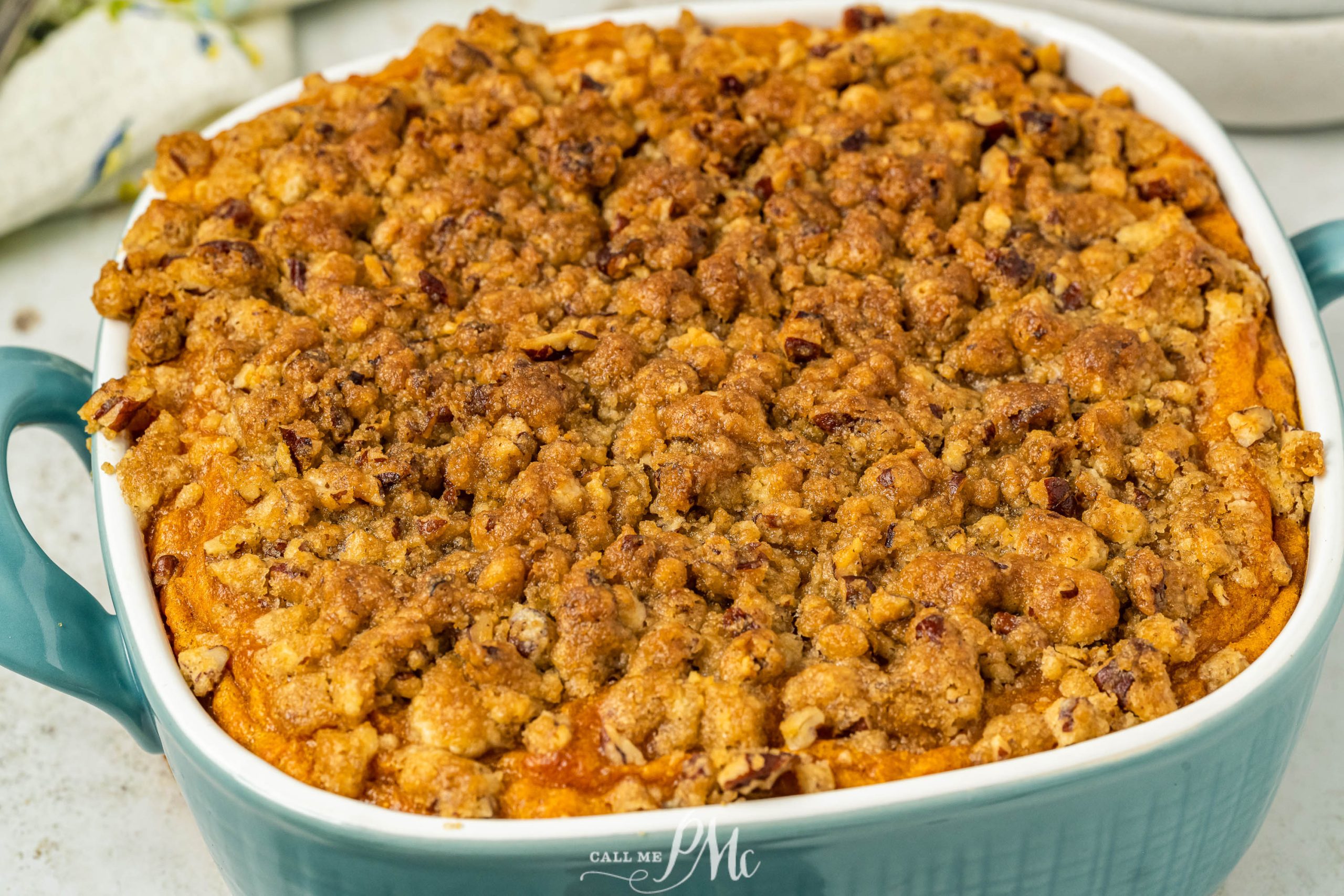 Sweet potato casserole in a blue dish.