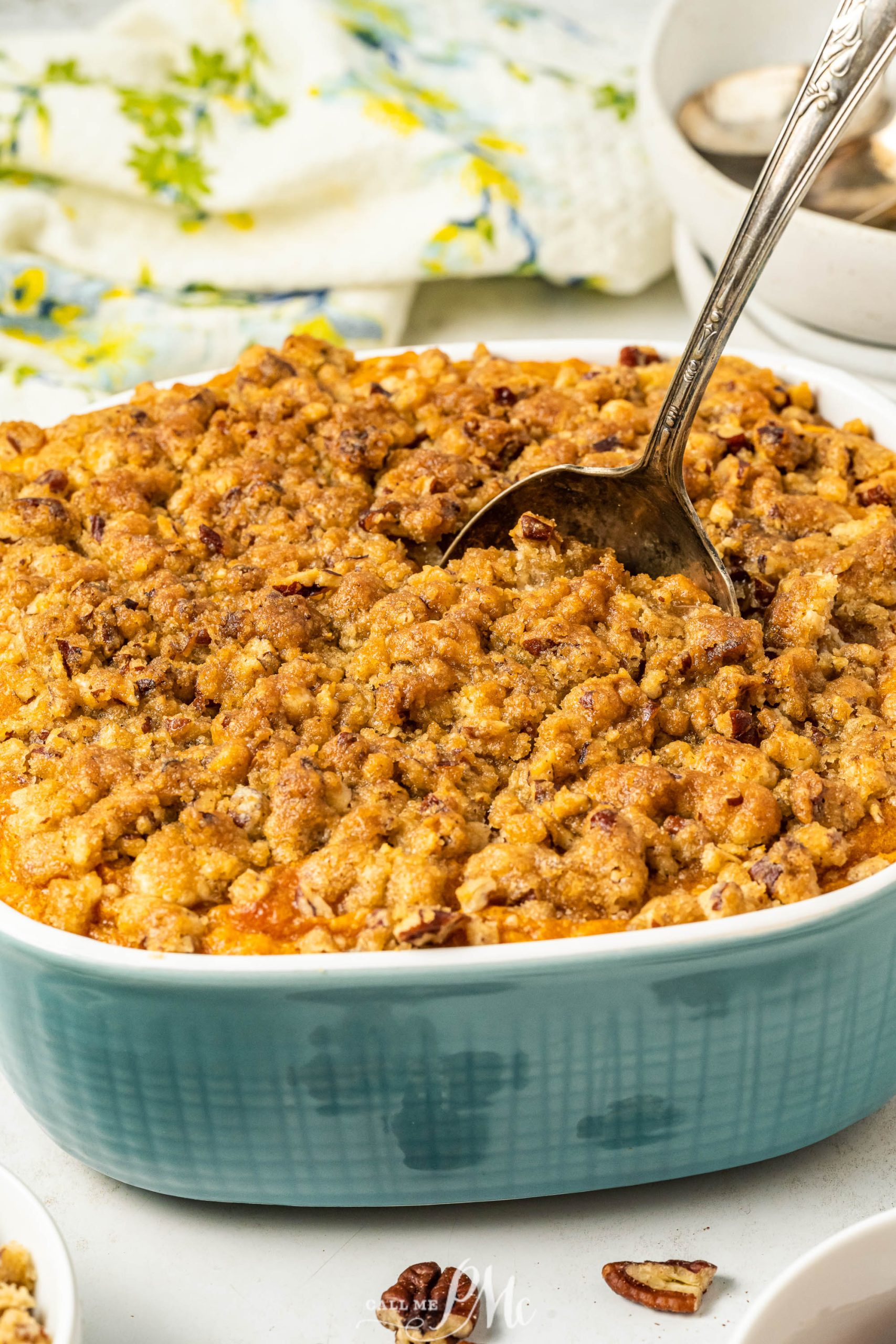 A casserole dish with a spoonful of cranberry pecan crumble.