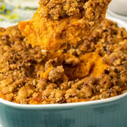 A spoonful of sweet potato casserole in a blue dish.