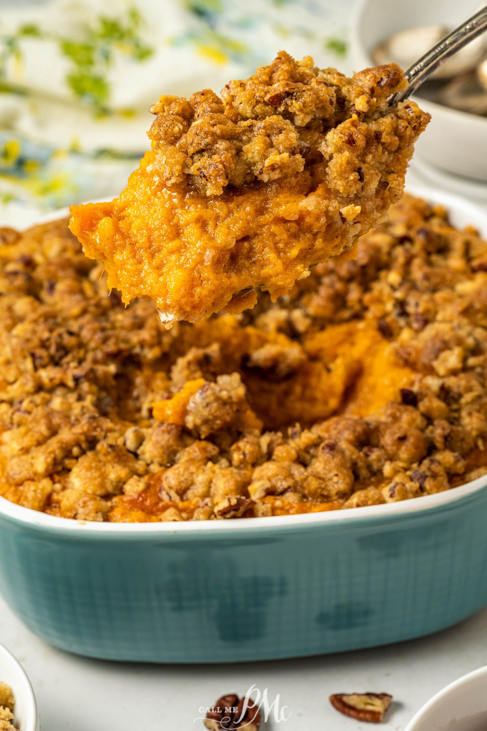 A spoonful of sweet potato casserole in a blue dish.