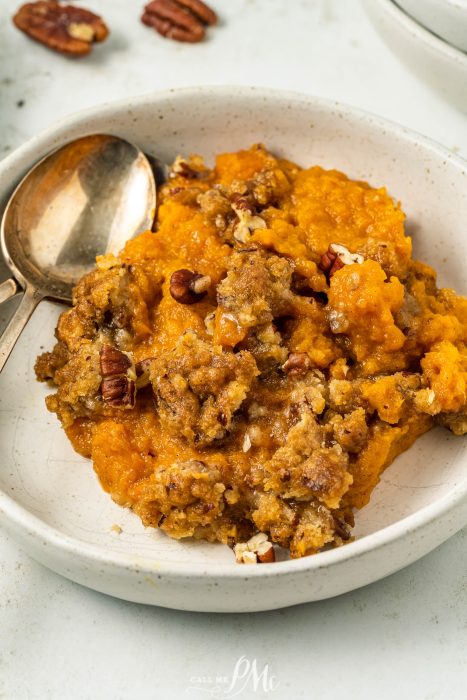 Air Fryer Sweet Potato Souffle in a white bowl with a spoon.