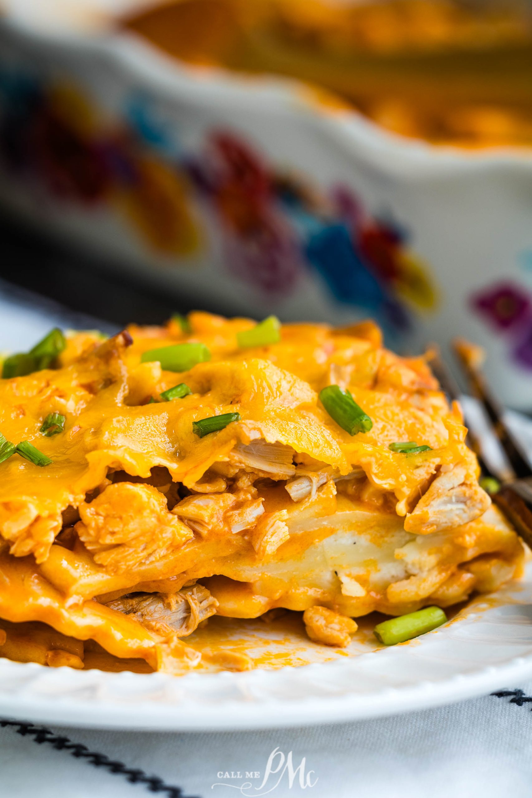 Chicken enchilada casserole on a white plate.