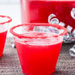 Two cups with red liquid in them on a table.