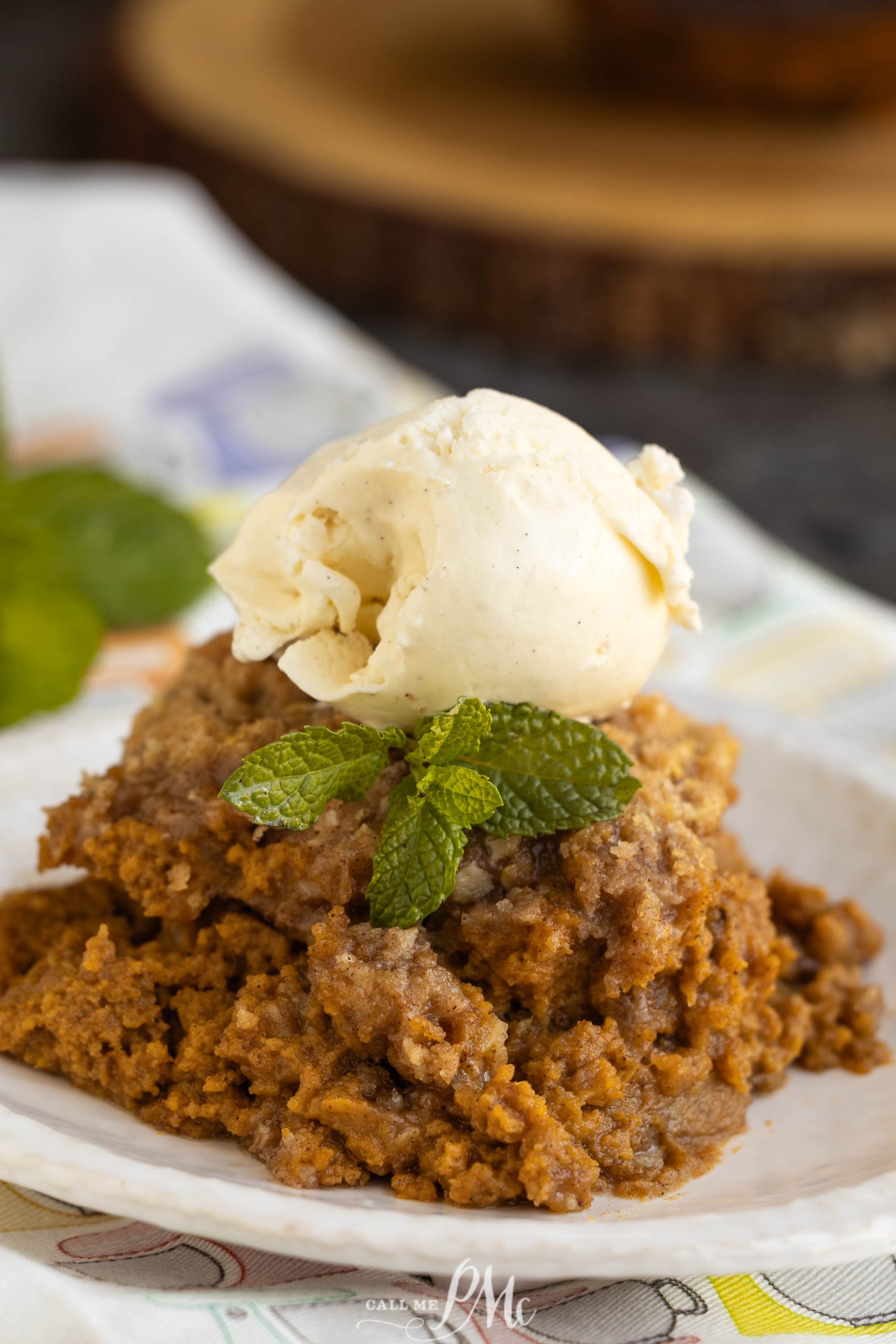 A plate topped with ice cream and a piece of pumpkin pie.