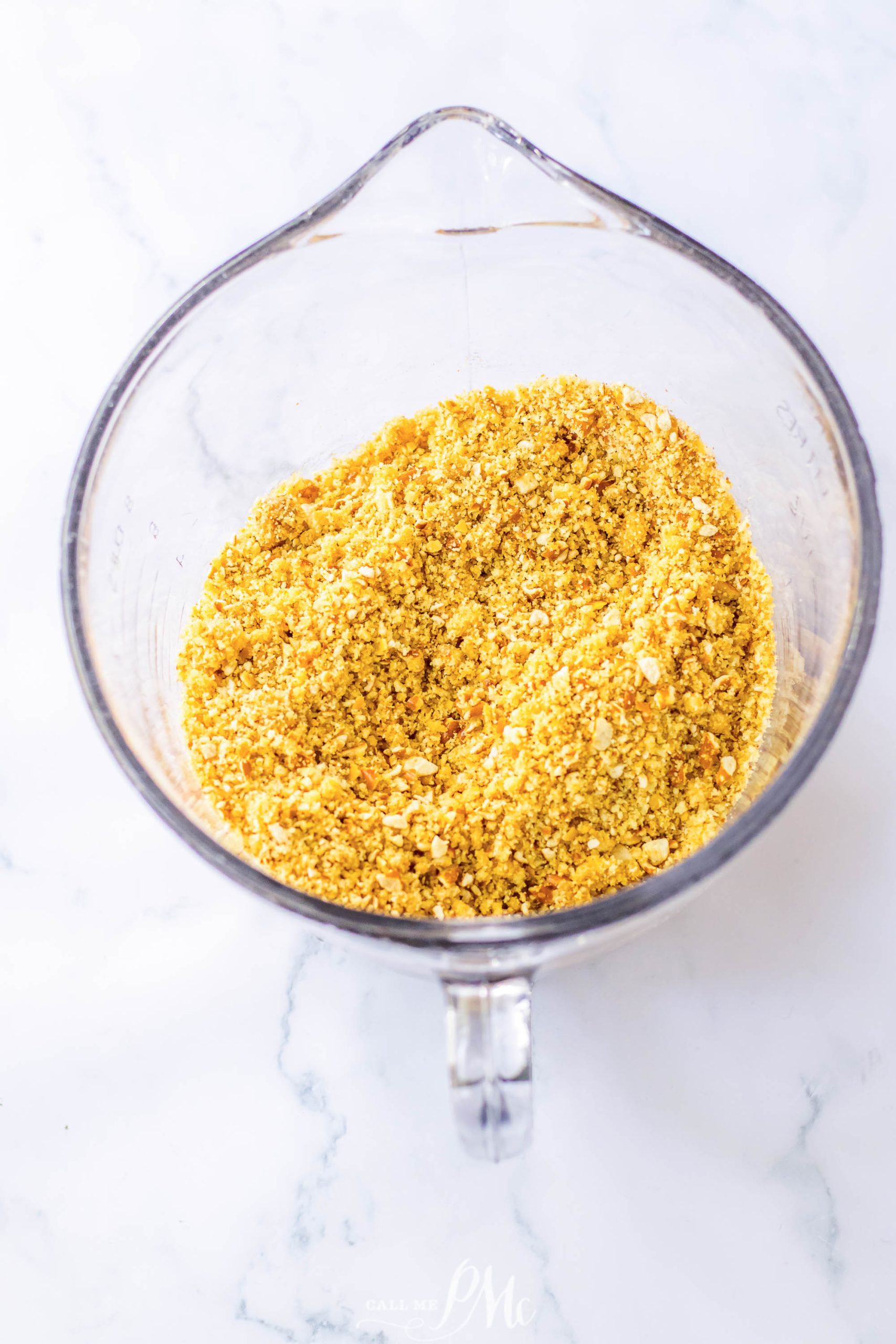 A glass bowl filled with toasted sesame seeds.