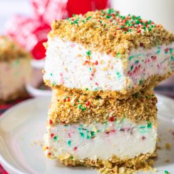 A stack of christmas ice cream bars on a plate.