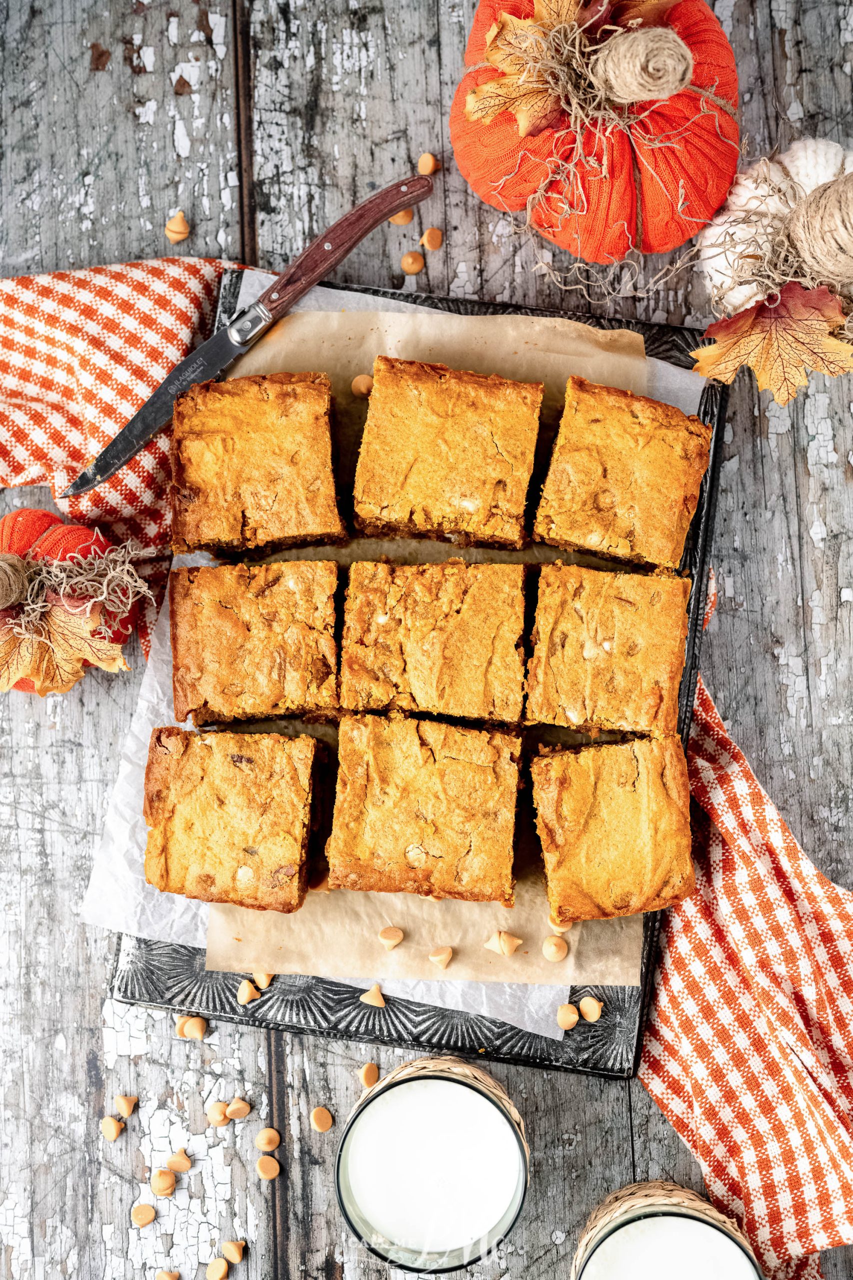 Pumpkin bars on a wooden cutting board.