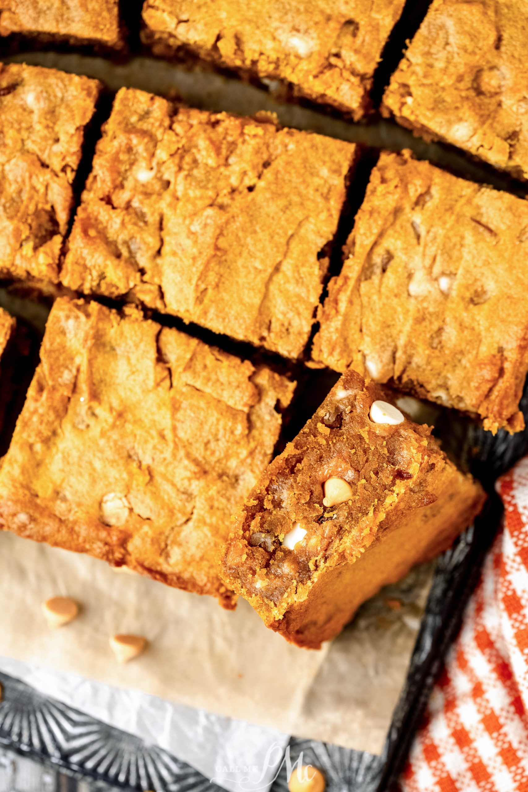 Best Pumpkin Blondies cut into pieces on a baking sheet.