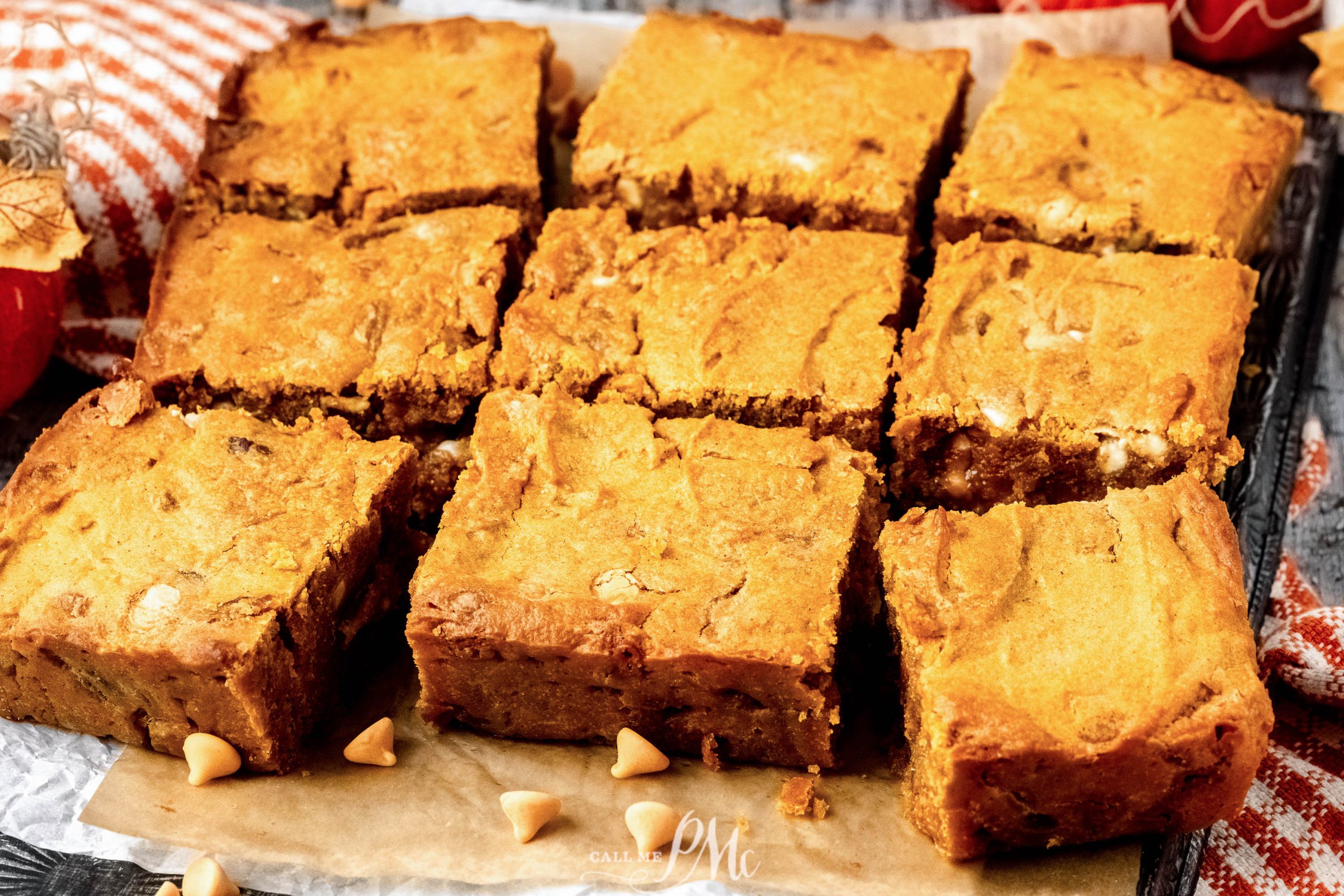 Pumpkin blaondie bars on a baking sheet.