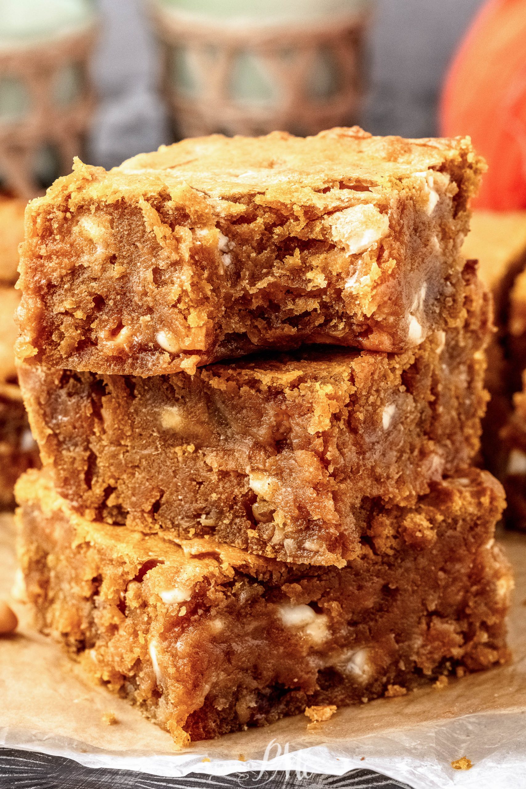 A stack of pumpkin blondies on top of a piece of paper.