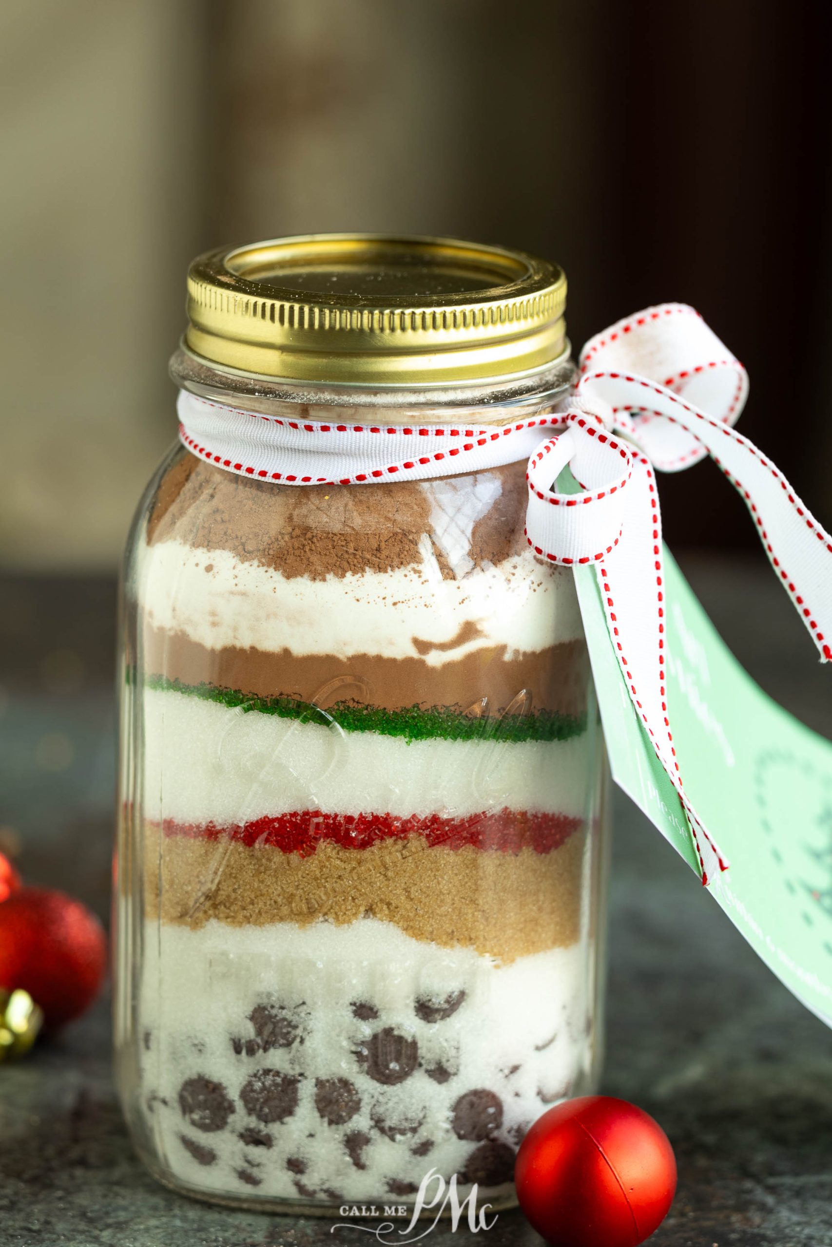 A jar with a christmas cookie mix in it.