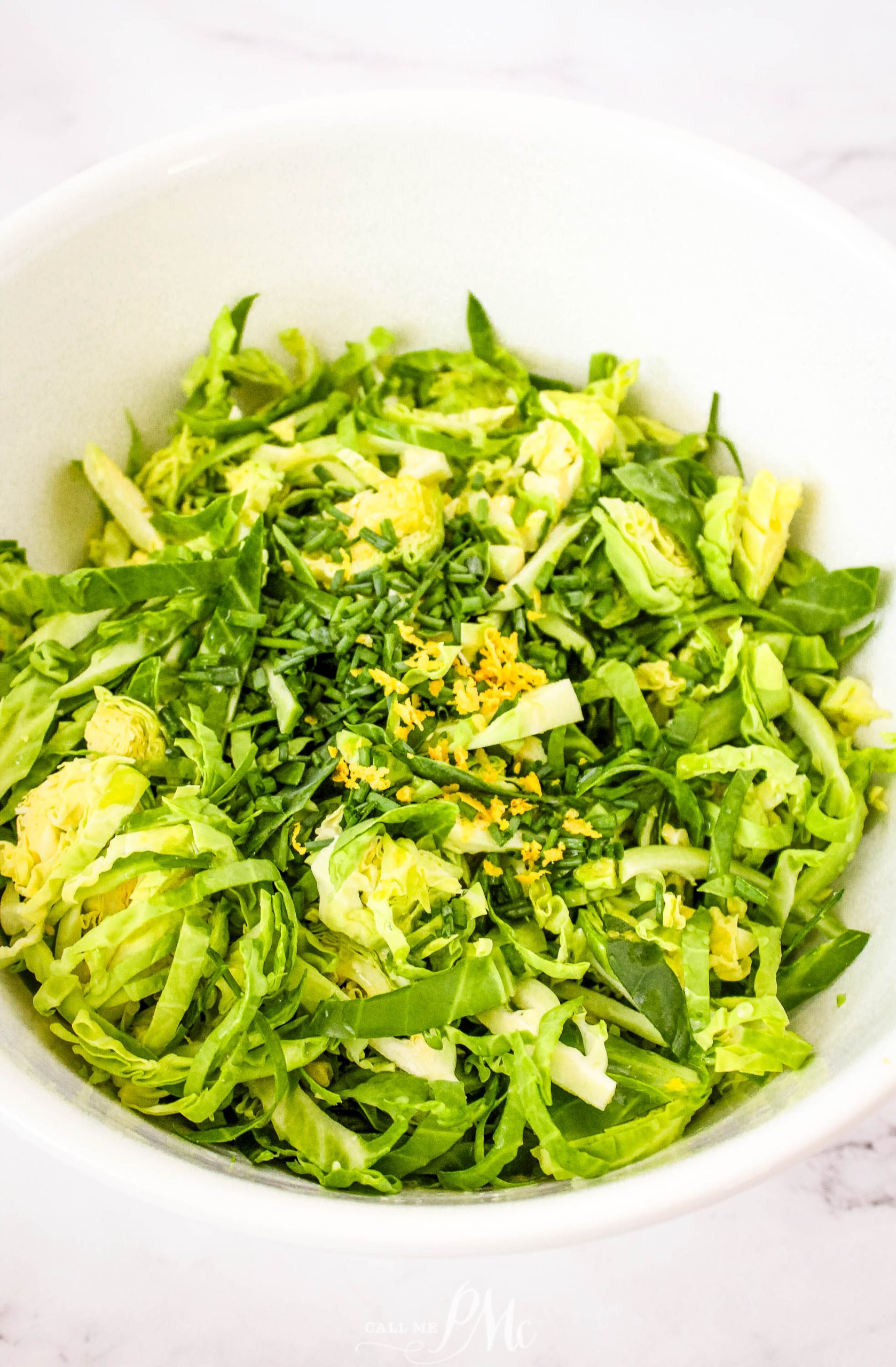 Brussels sprout salad in a white bowl.