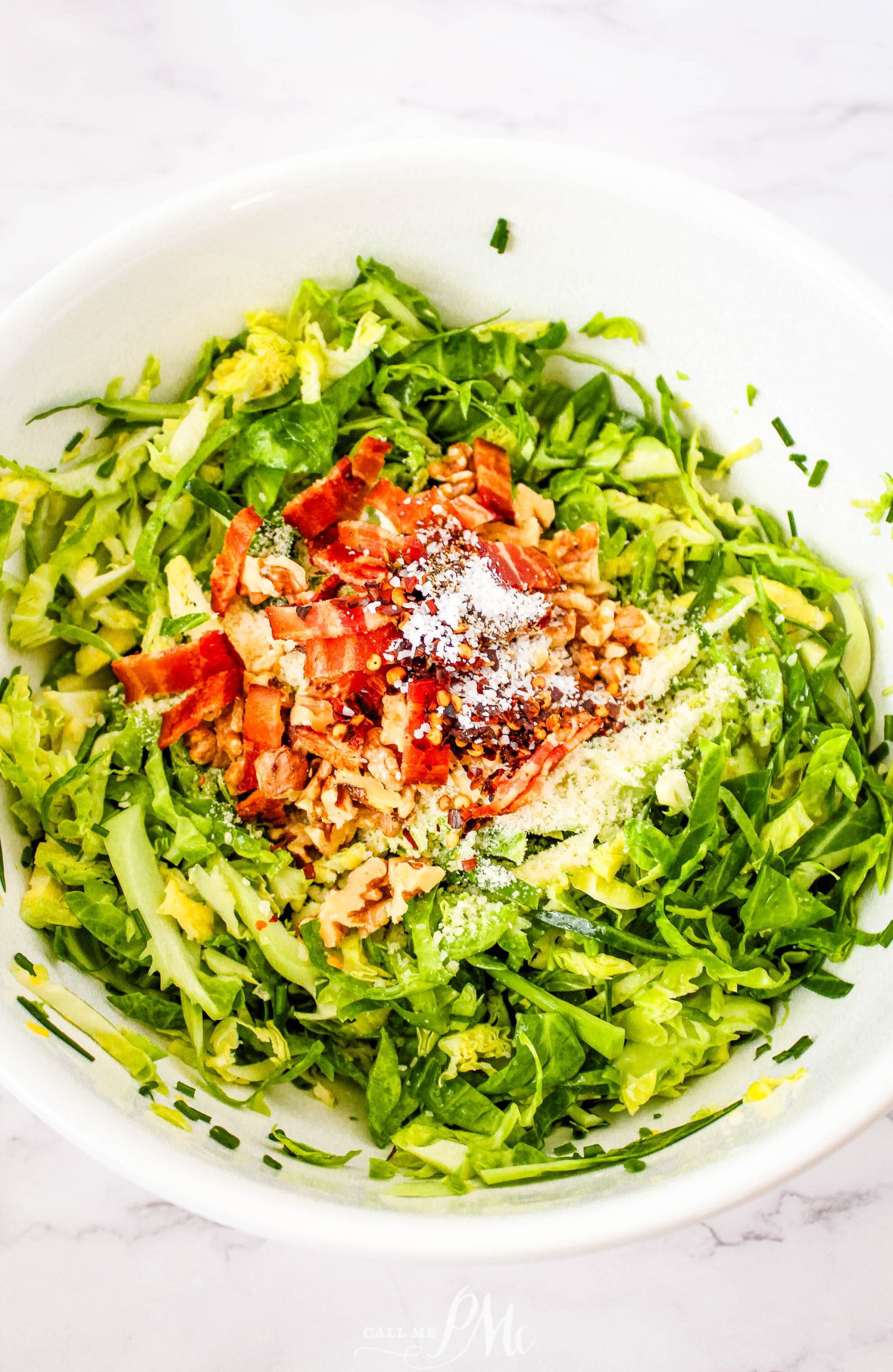 Brussels sprout salad in a white bowl.