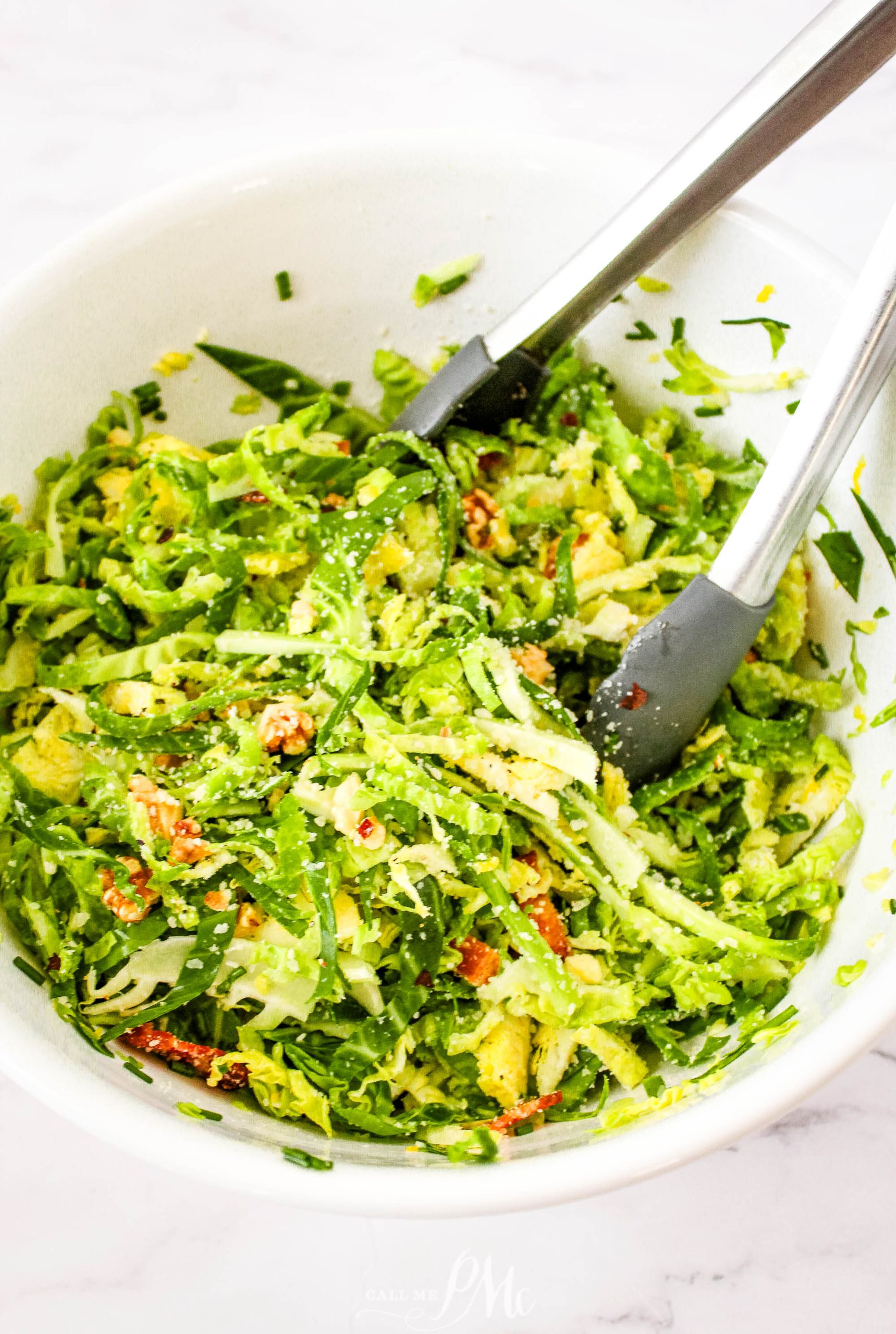 Brussels sprout salad in a white bowl.