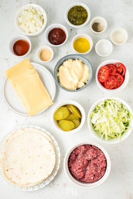 A plate with various ingredients for making a burrito.