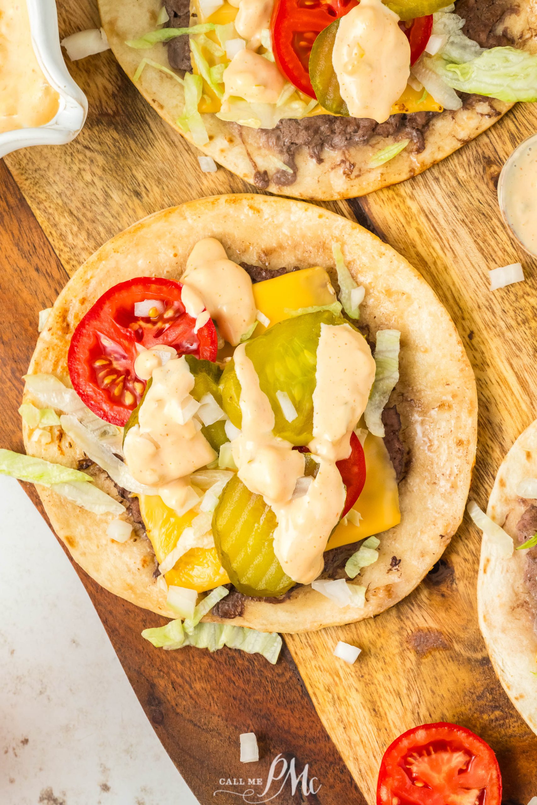 Four Viral Smash Burger Tacos on a wooden cutting board.