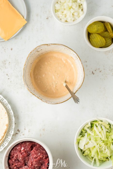 The ingredients for a cheese dip are laid out on a table.