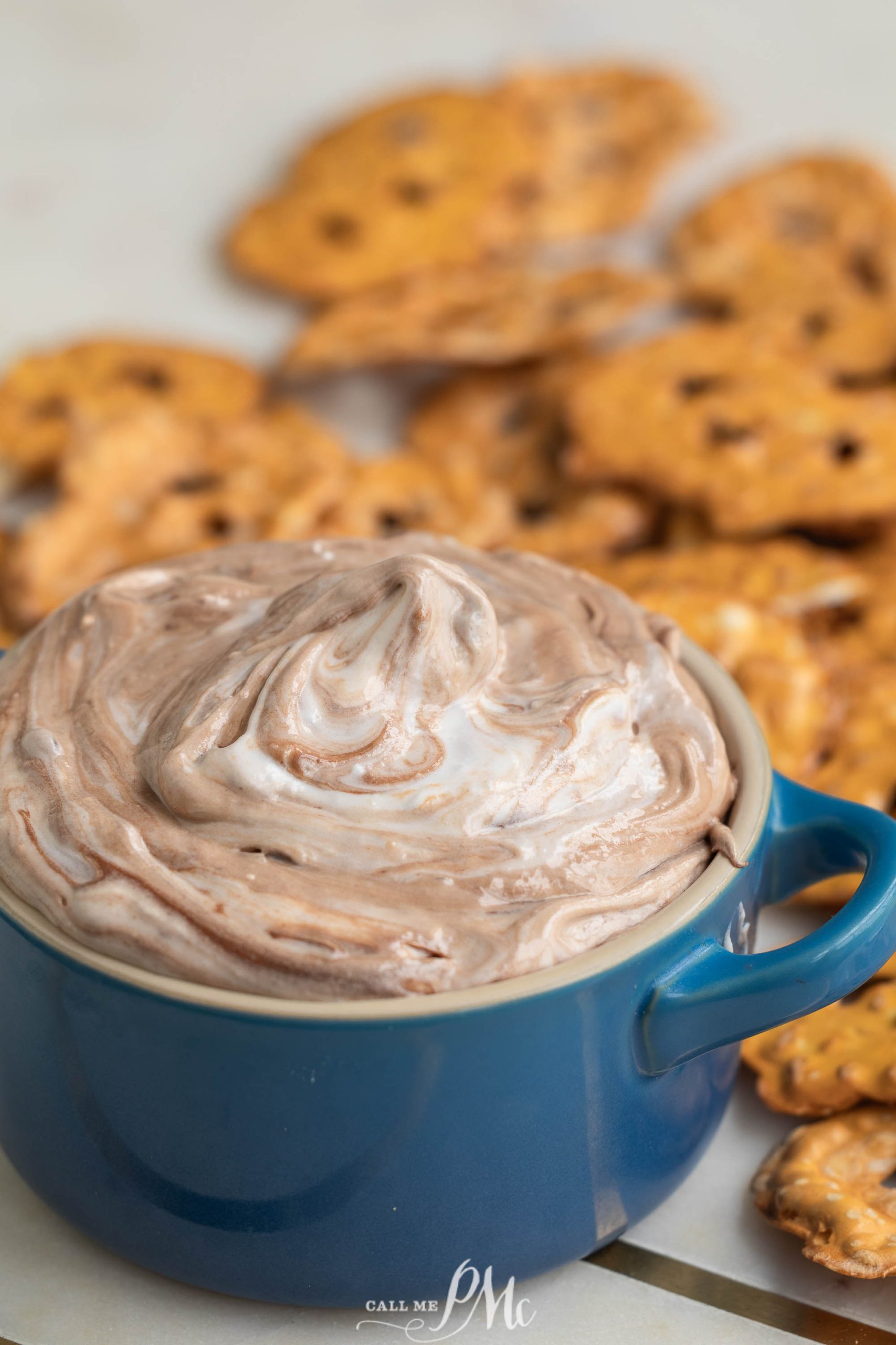 Chocolate pretzel dip in a blue bowl with crackers.