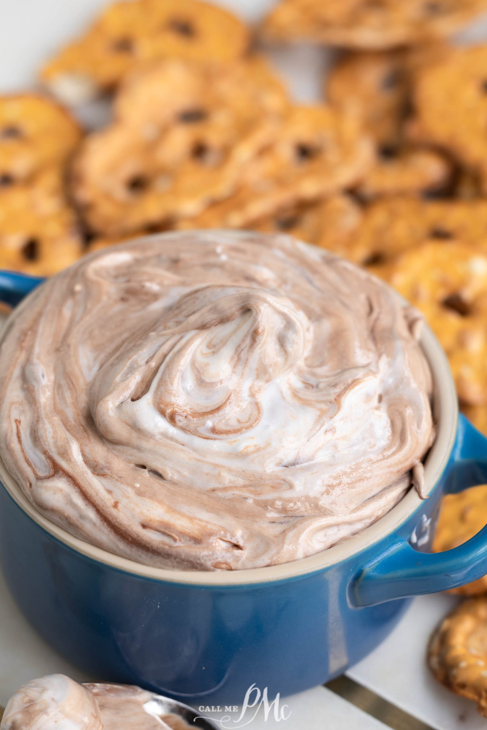 Chocolate pretzel dip in a blue bowl.