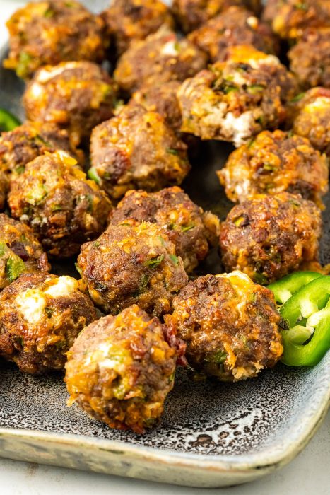 Jalapeno Popper Meatballs on a plate with jalapenos.