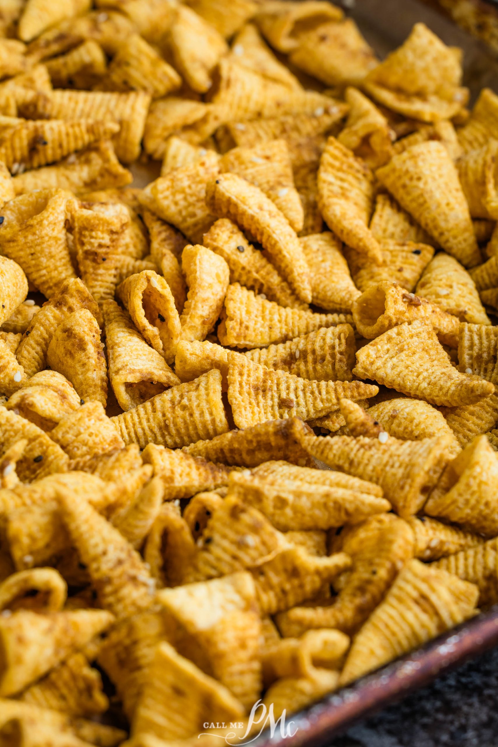 Bugles Chex Mix in a baking pan.