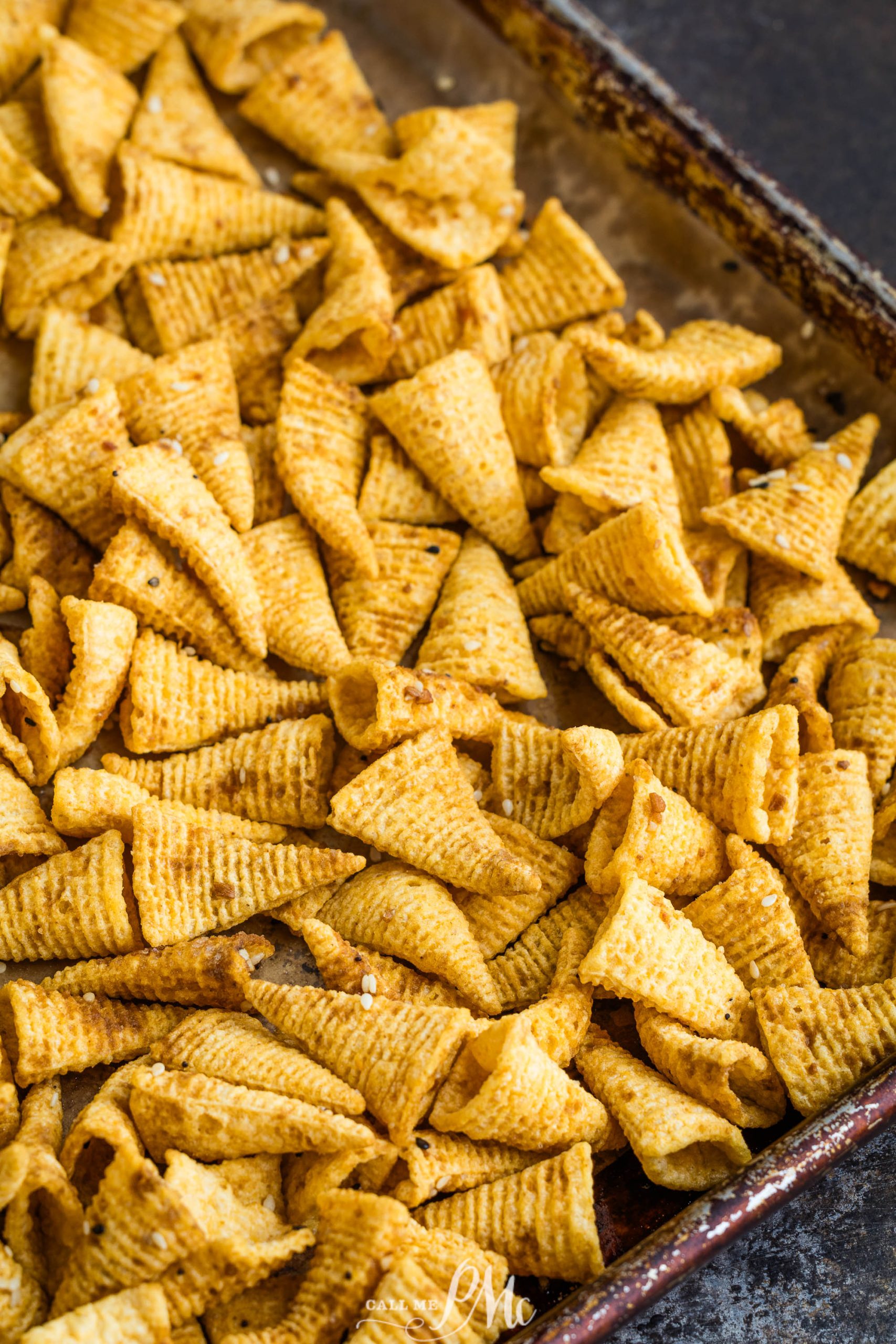 A baking sheet with Bugles on it.