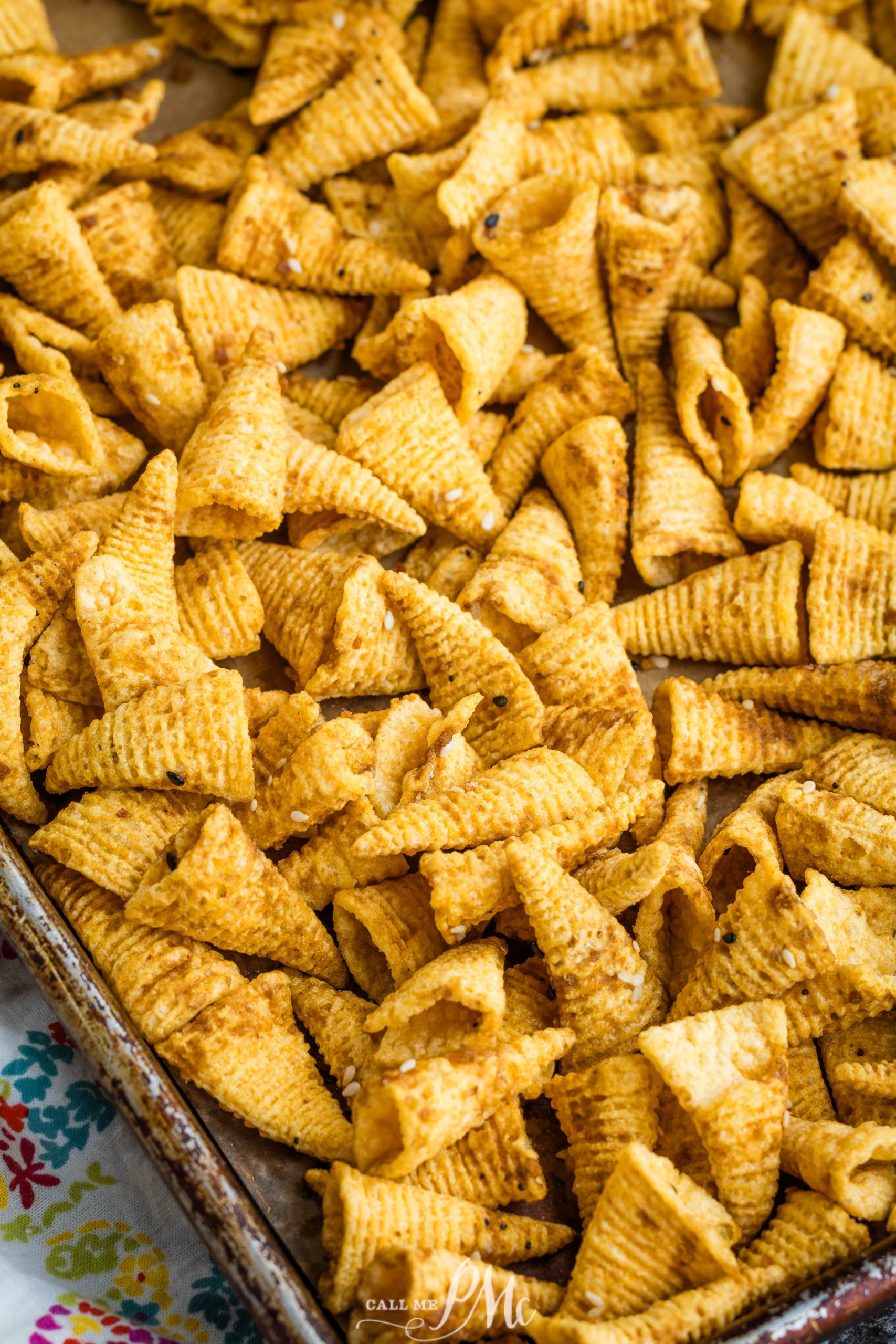 Snack mix on a baking sheet.