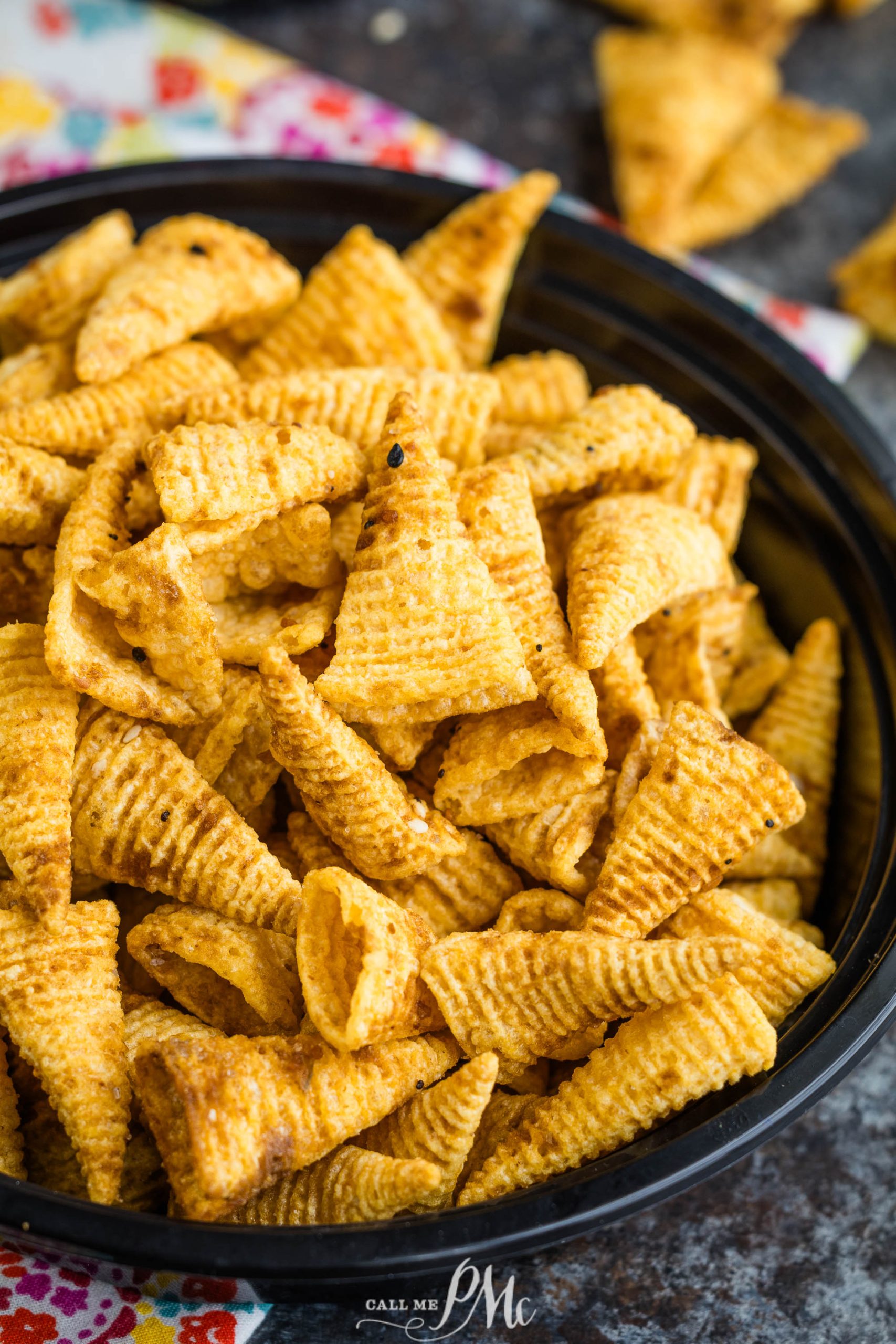 Bugles Chex Mix in a bowl on a table.