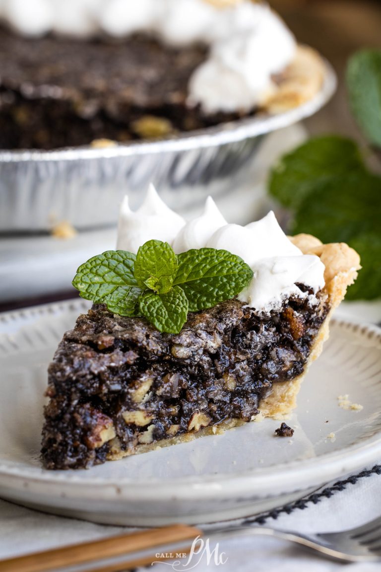 A slice of Chocolate Sawdust Pie with whipped cream and mint leaves.