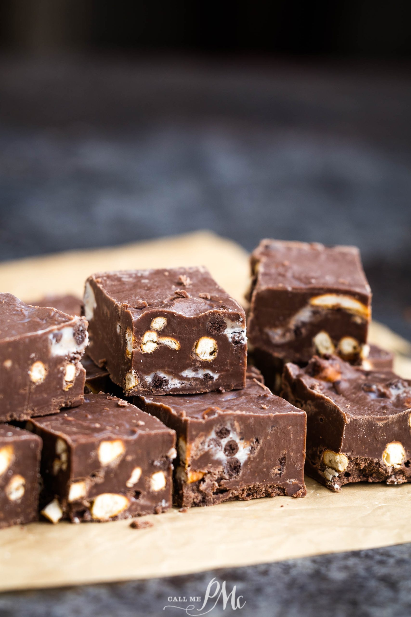 A piece of chocolate fudge on top of a piece of paper.