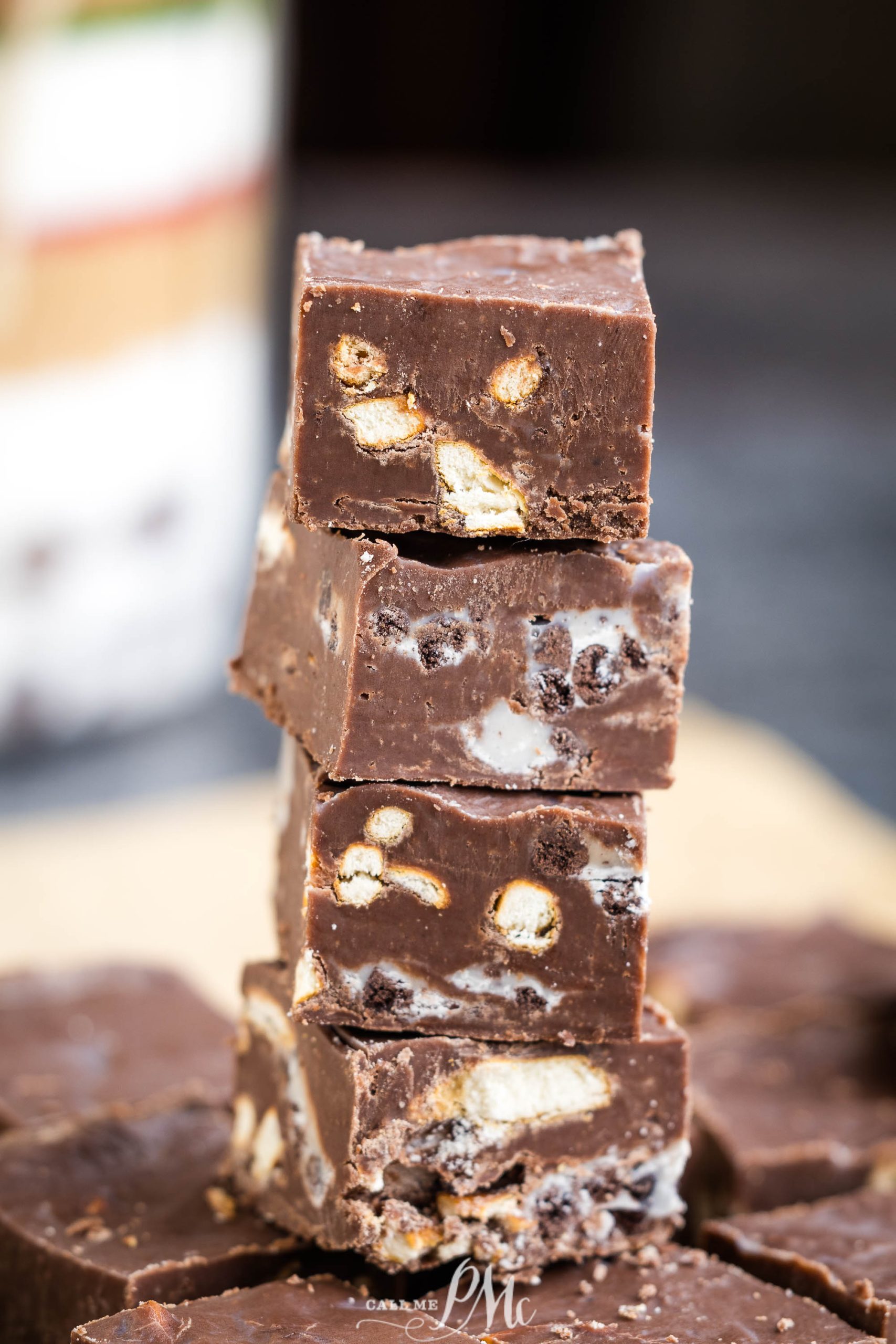 A stack of chocolate fudge sitting on top of a jar.