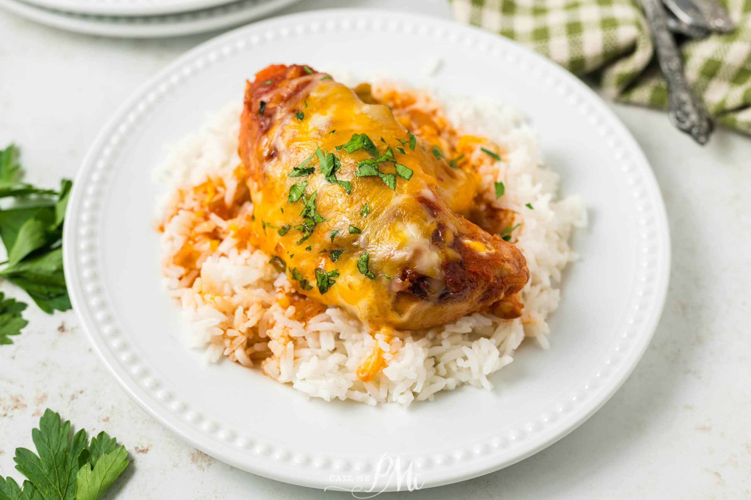 A plate of Crockpot Cheesy Salsa Chicken on a table.