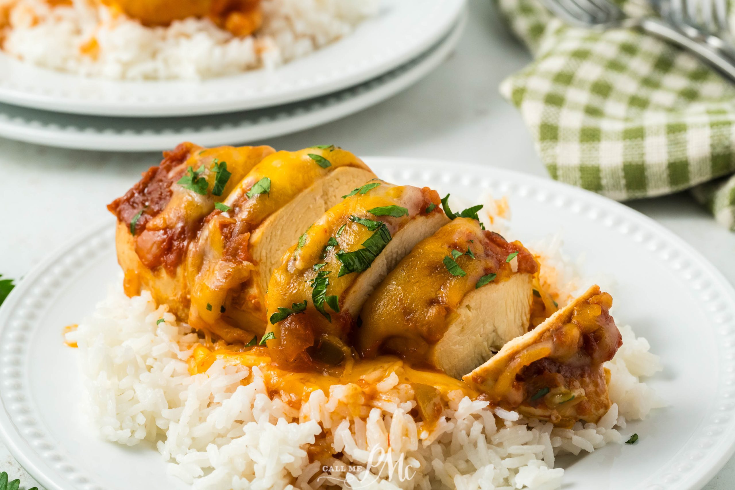 Crockpot Cheesy Salsa Chicken on a plate with rice and sauce.
