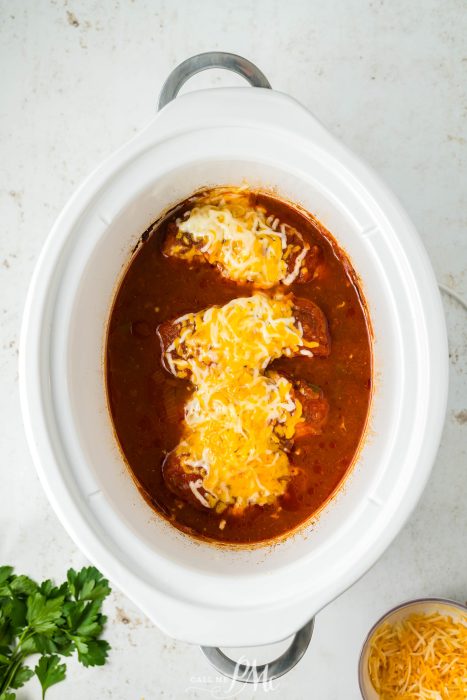 A crock pot full of Crockpot Cheesy Salsa Chicken.