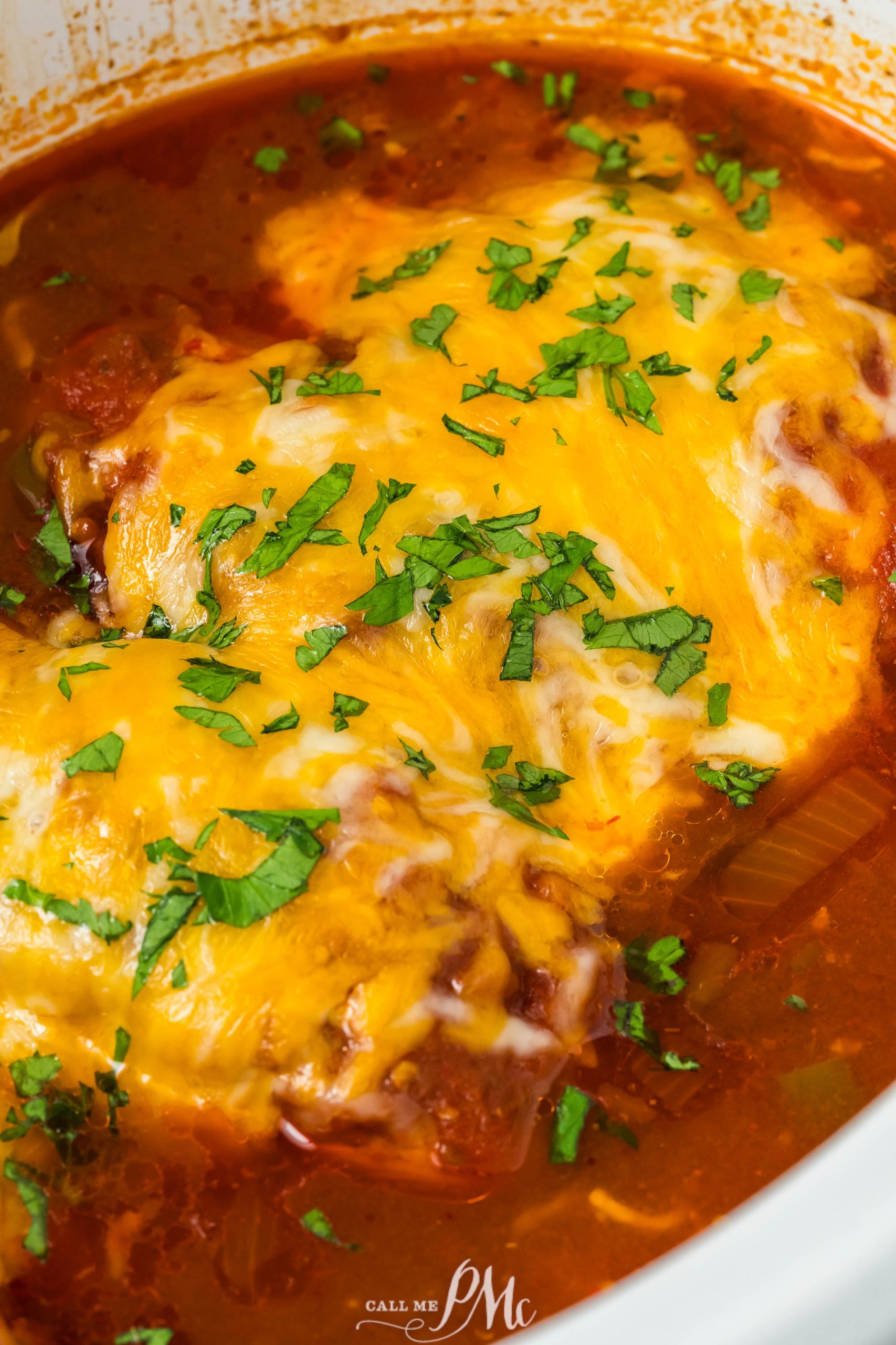 Crockpot Cheesy Salsa Chicken in a crock pot with cheese.