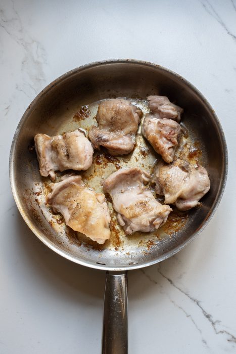 Fried chicken in a frying pan.