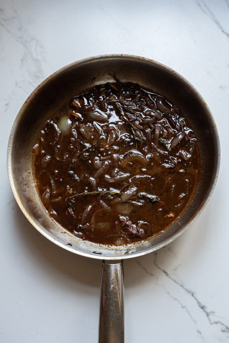 A frying pan with a brown sauce on it.