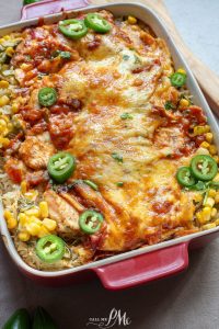 Mexican chicken enchilada in a red baking dish.