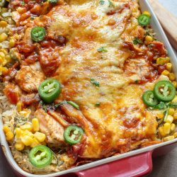 Mexican chicken enchilada in a red baking dish.