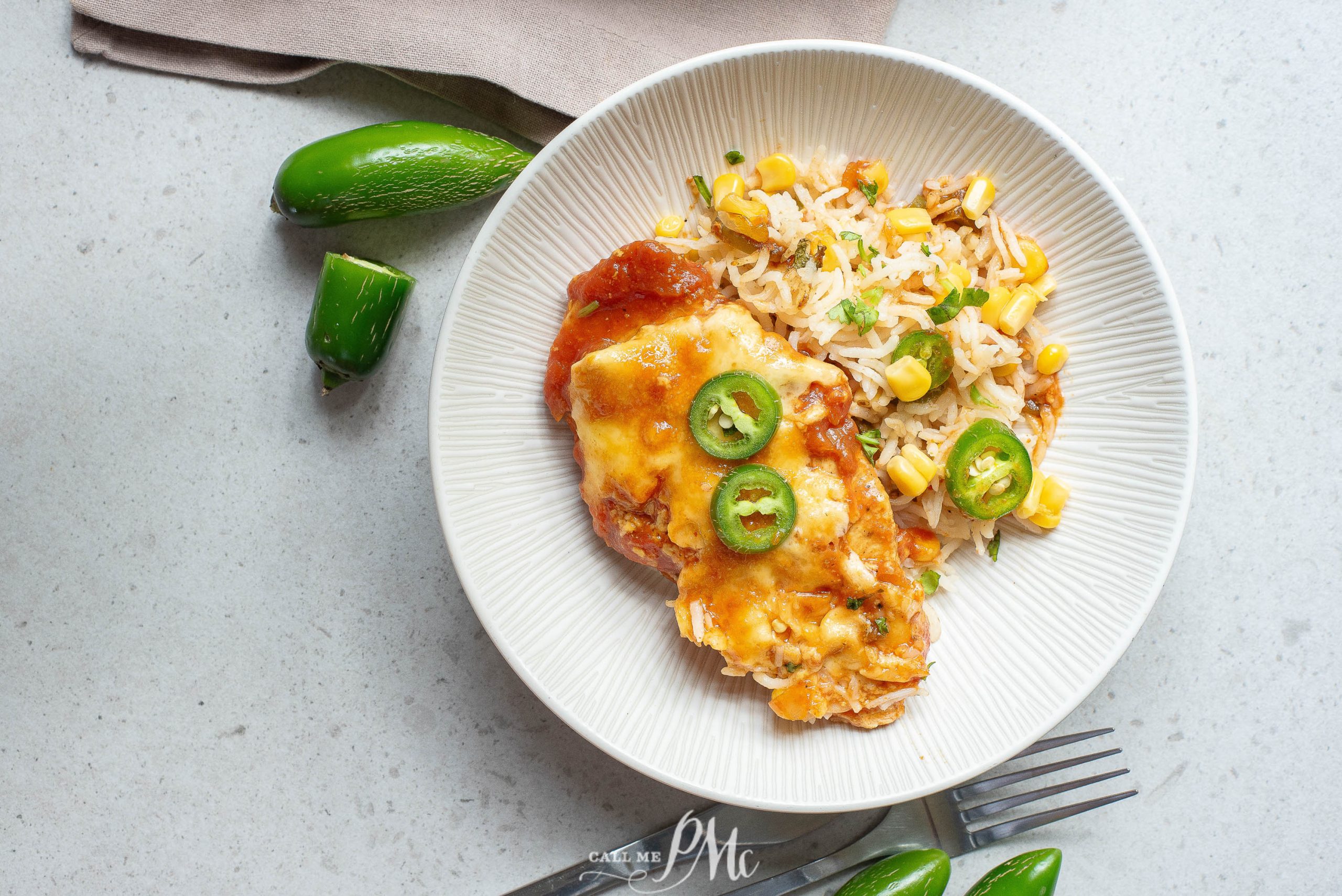 Mexican chicken with rice and jalapenos on a plate.