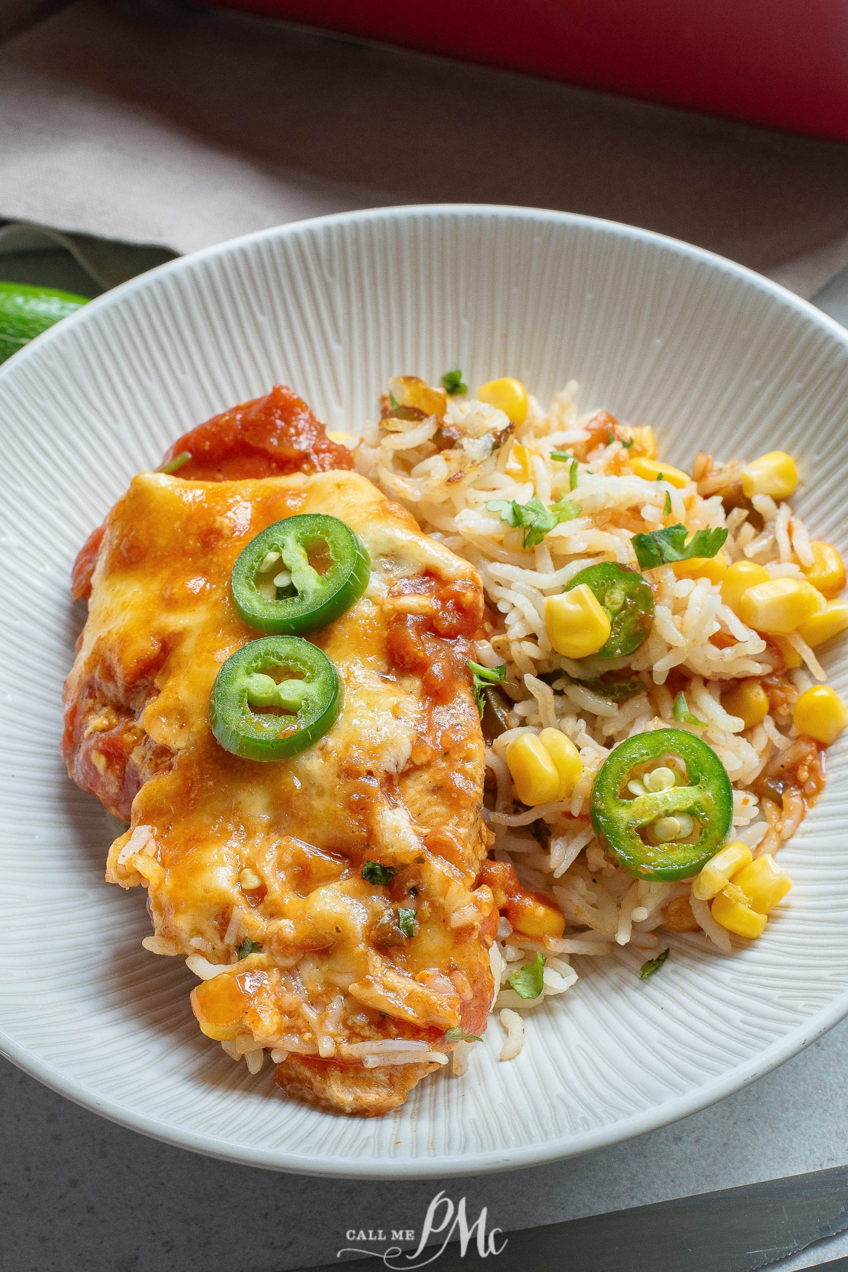 Mexican chicken with rice and corn on a white plate.