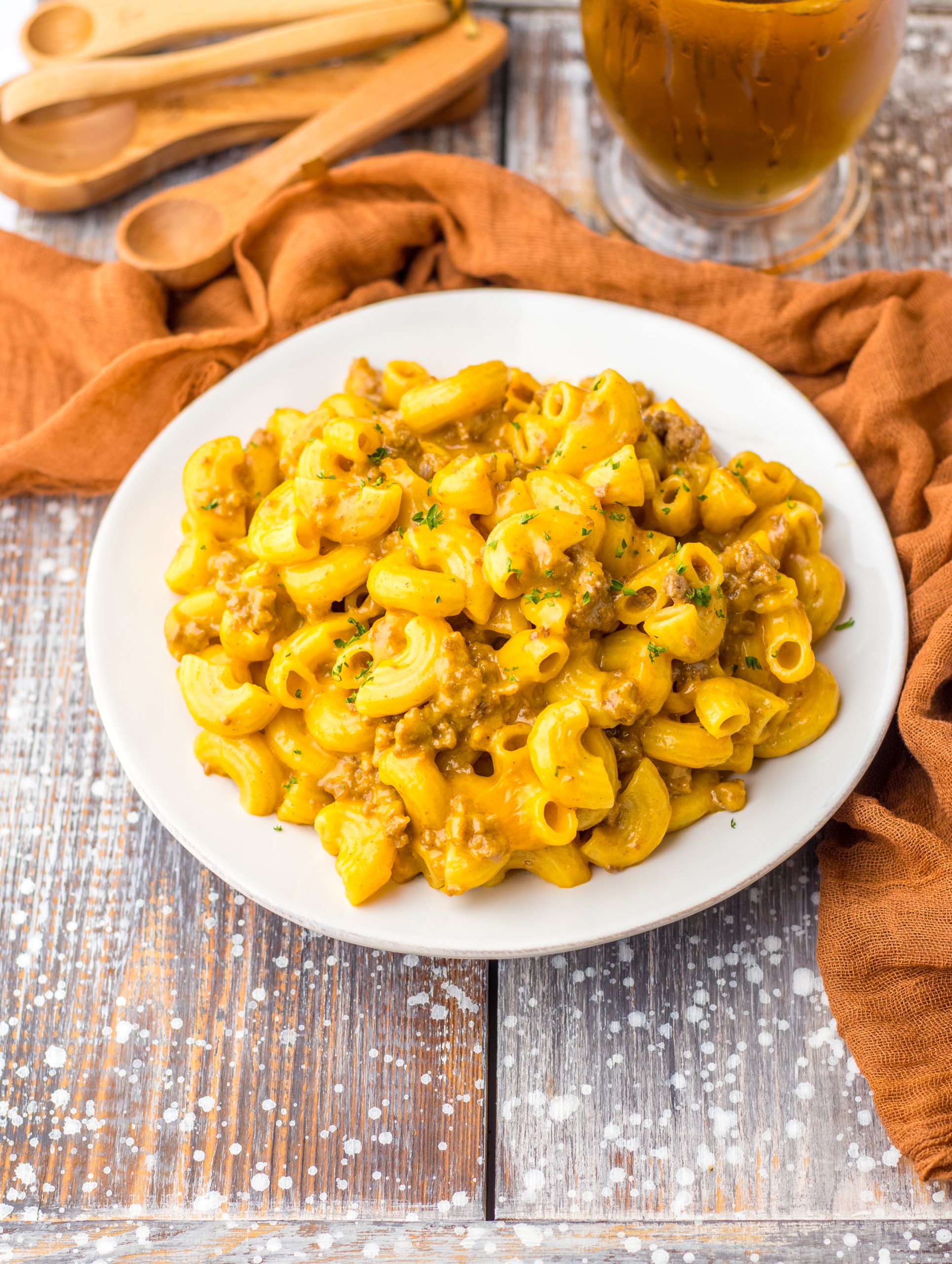 A plate of One Pot Cheesy Beef Macaroni on a wooden table.