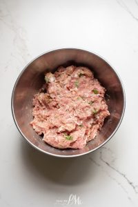 Meat in a bowl on a marble counter.