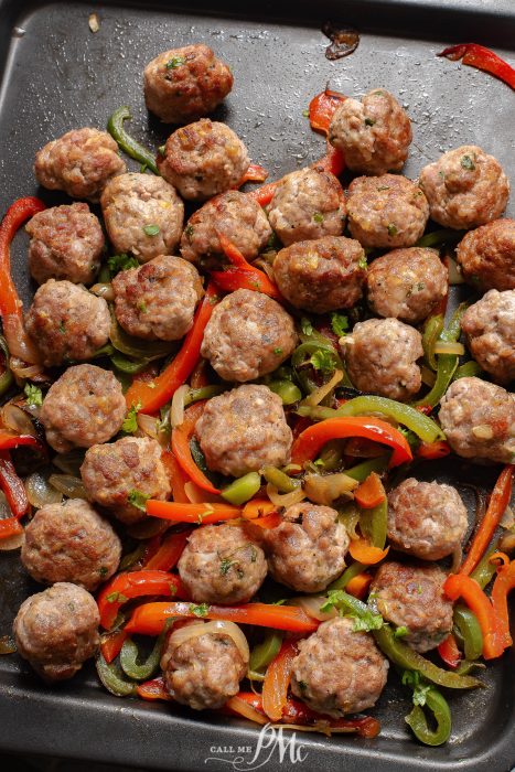 A pan with meatballs and peppers on it.