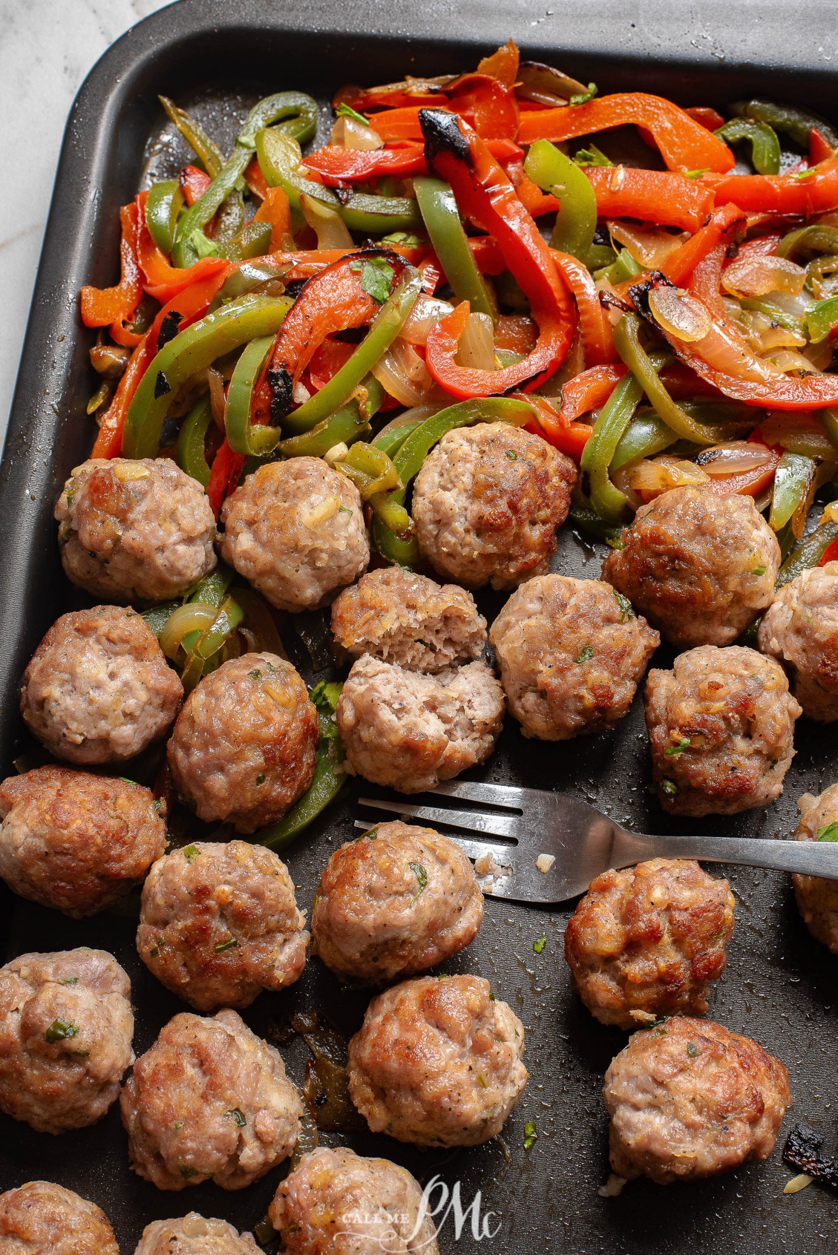 Beef and peppers on a baking sheet.