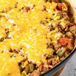 A skillet full of cheesy, cheesy, cheesy, cheesy, .