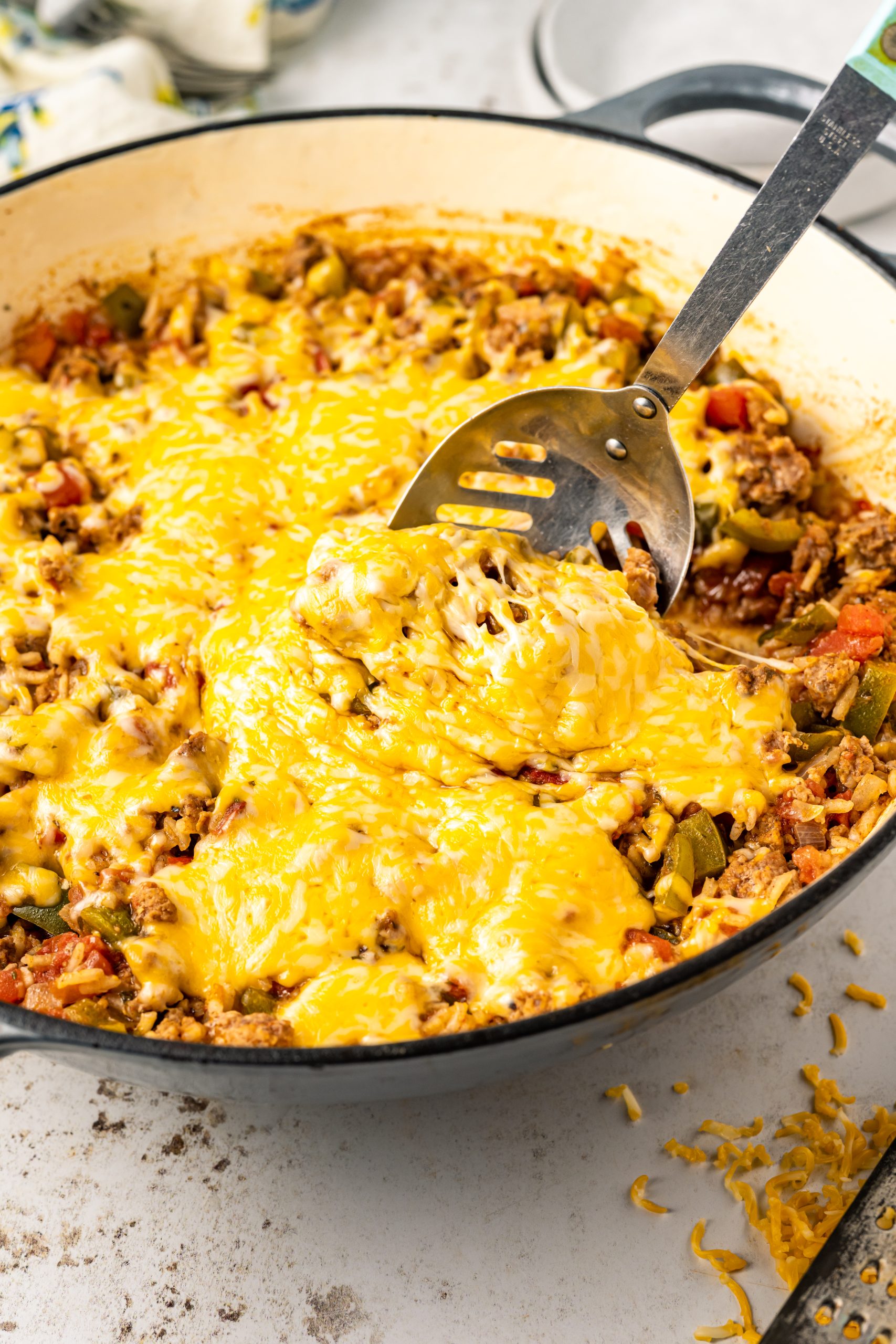 A skillet full of beef and cheese.