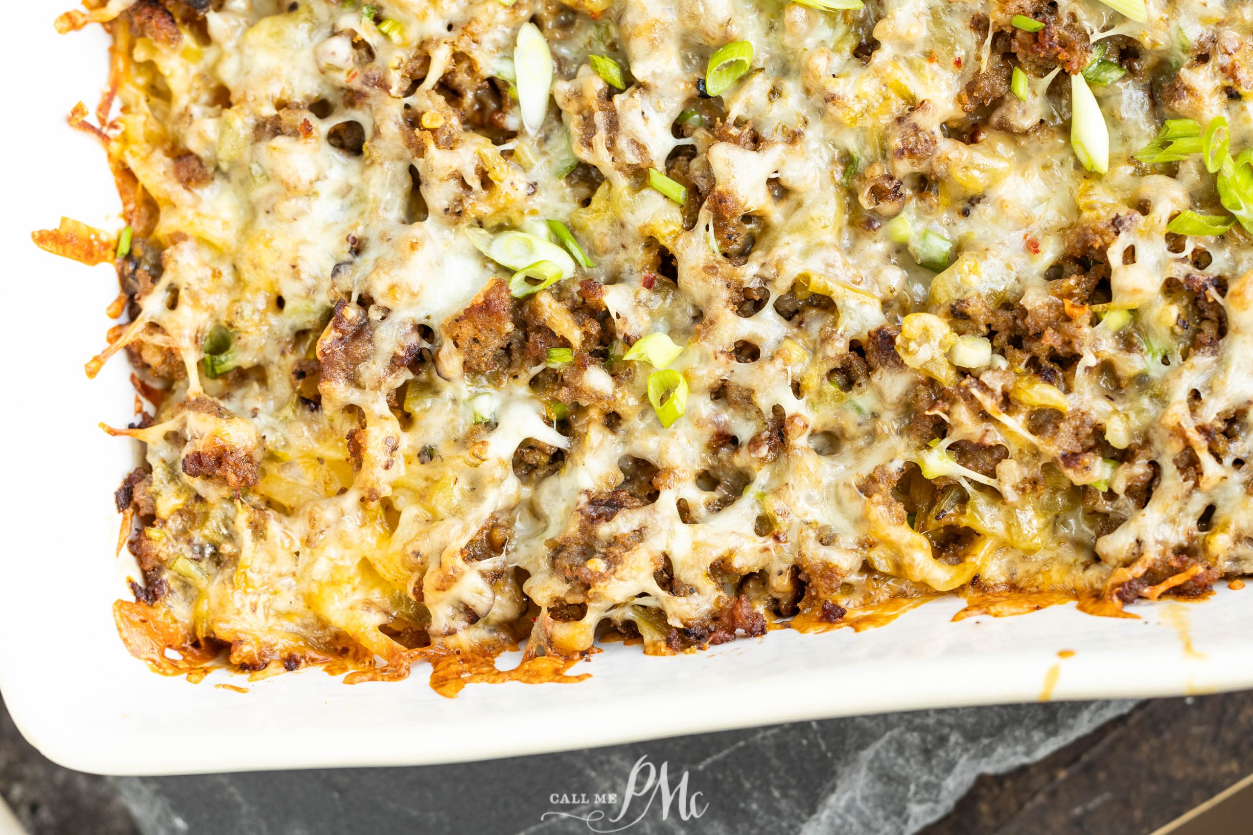 Overnight Sausage Hash Brown Casserole in a white dish.