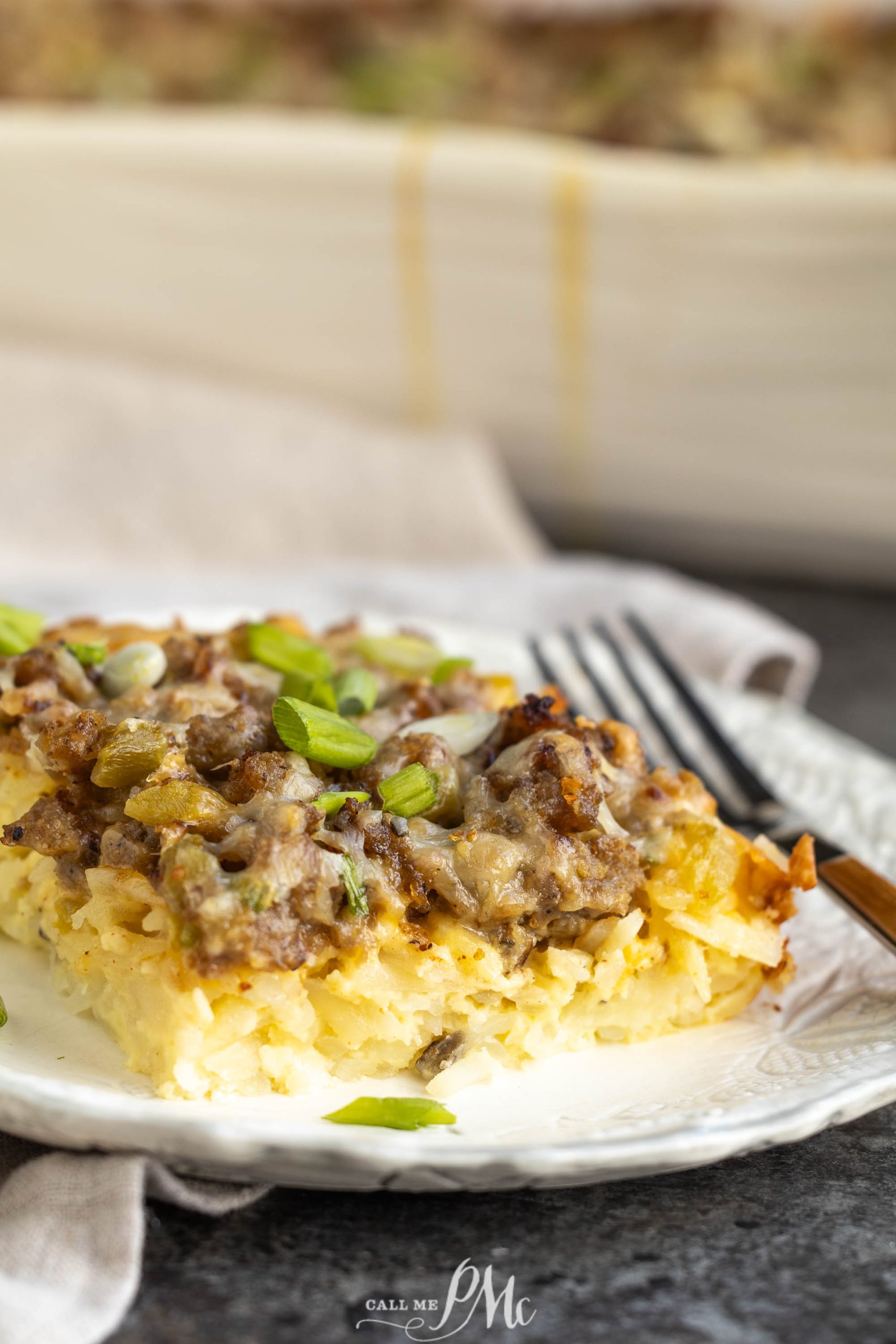 Breakfast casserole on a plate with a fork.