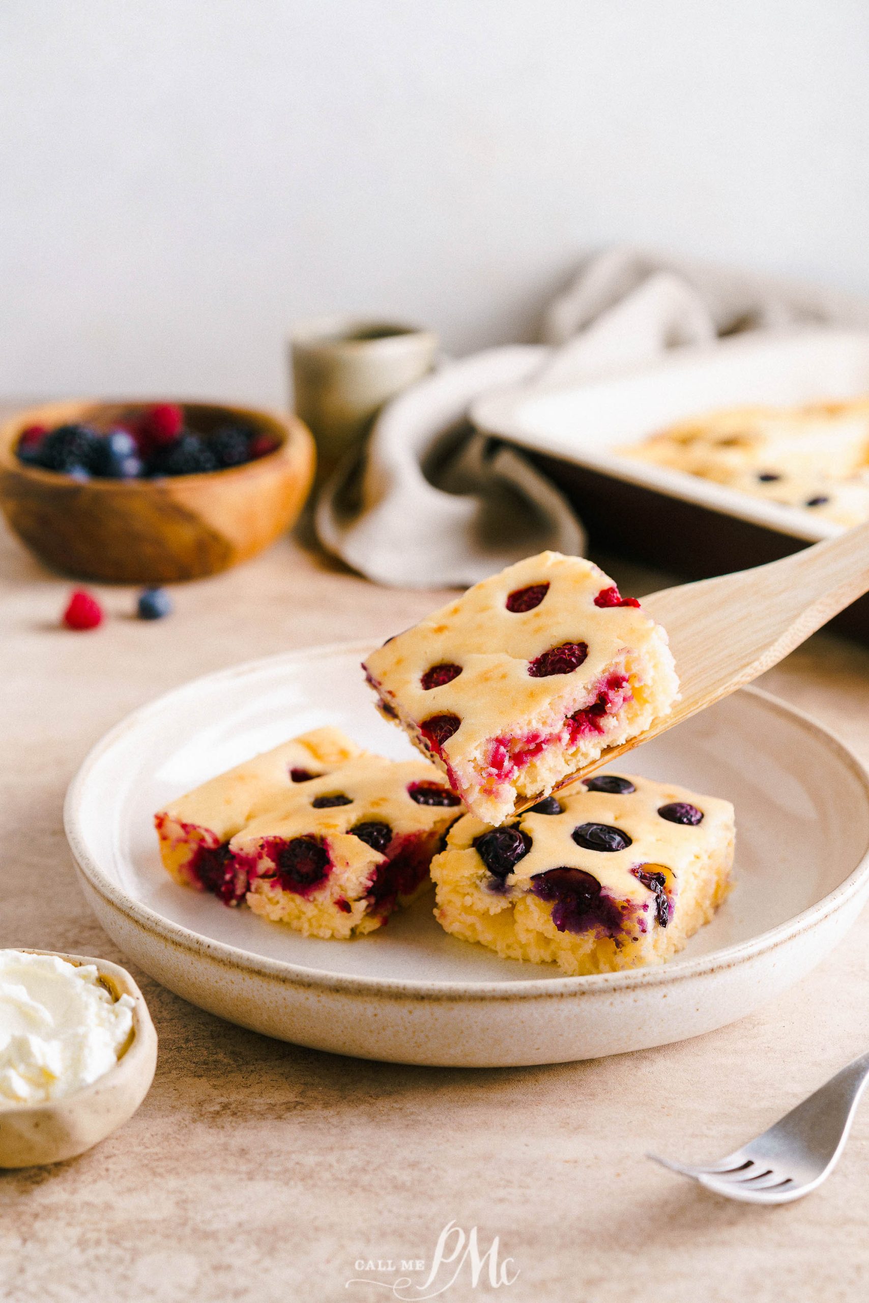 A plate of berry bars with a fork on it.